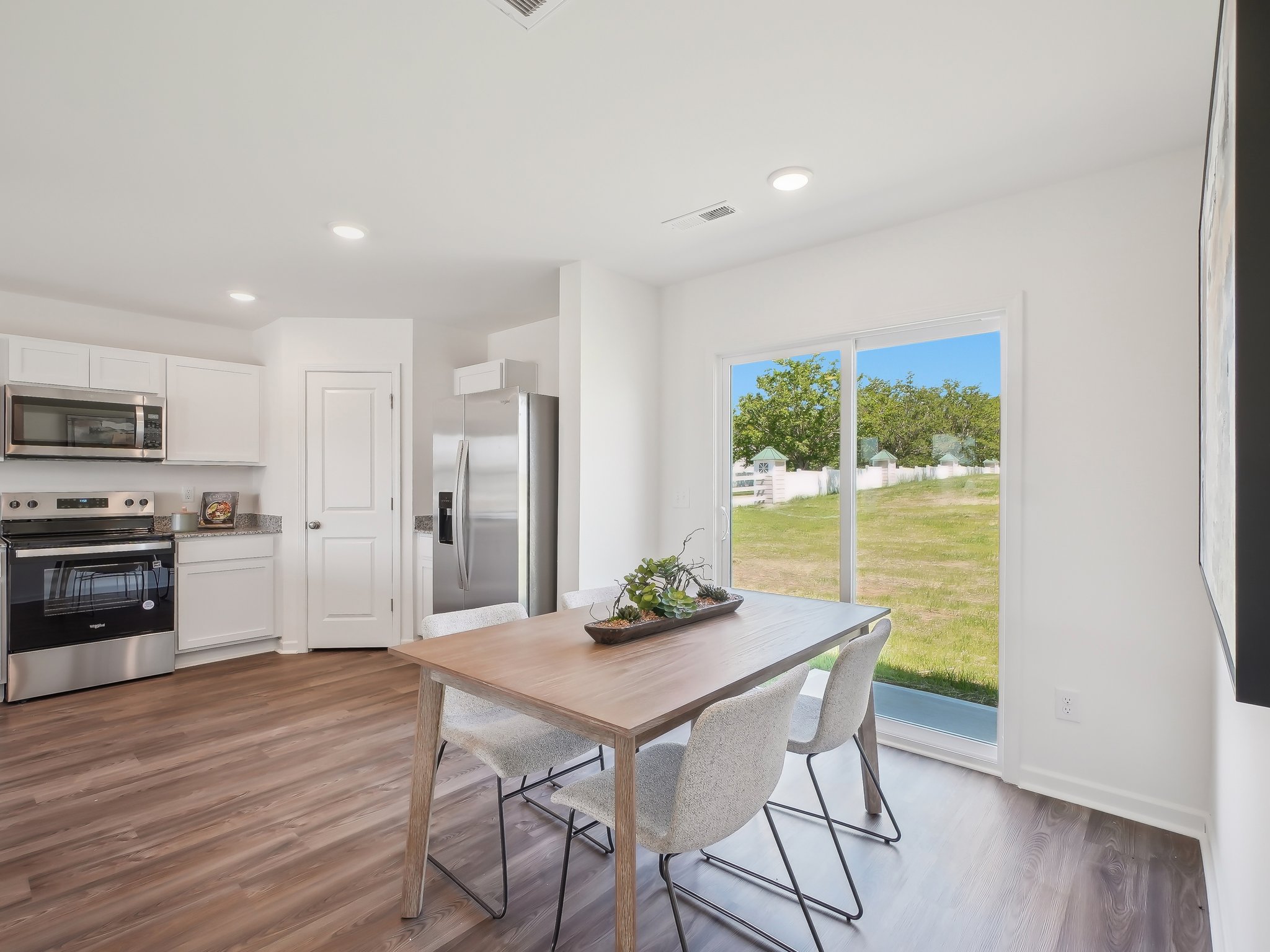 A kitchen with a table and chairs.