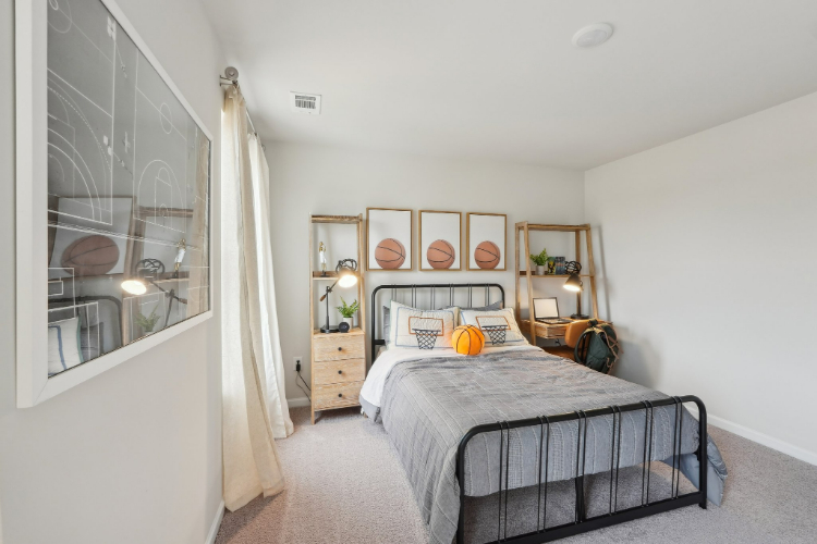 A bedroom with a bed and a window.