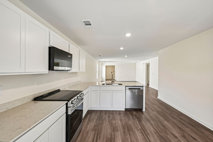 A kitchen with white cabinets.