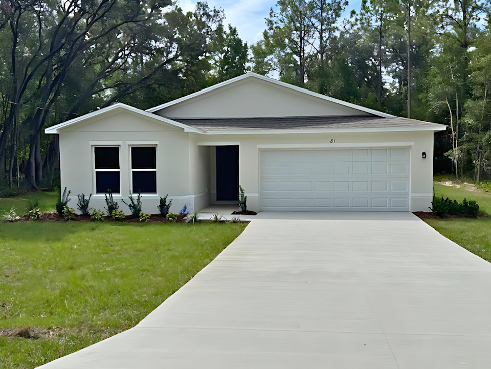 A white house with a garage.