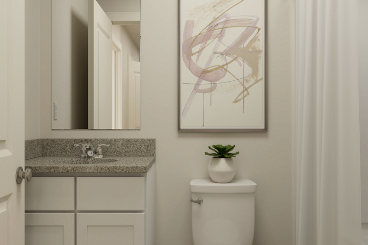 A bathroom with a plant on the wall.