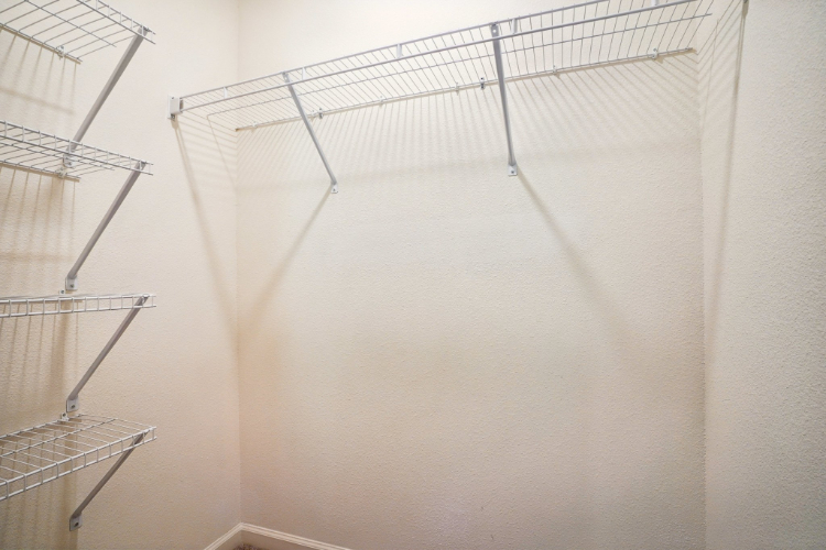 A white wall with a metal ladder.
