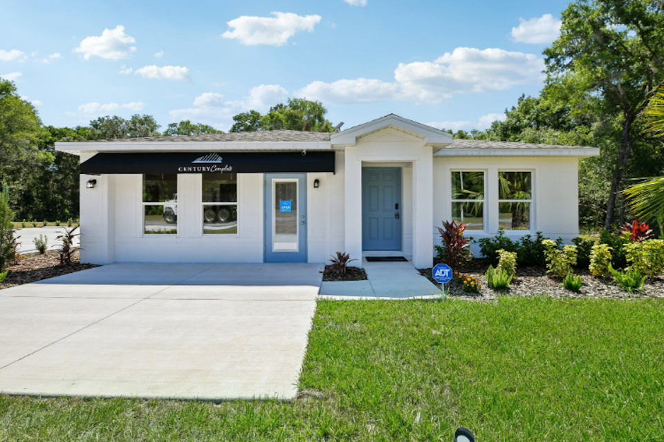 A white house with blue doors.