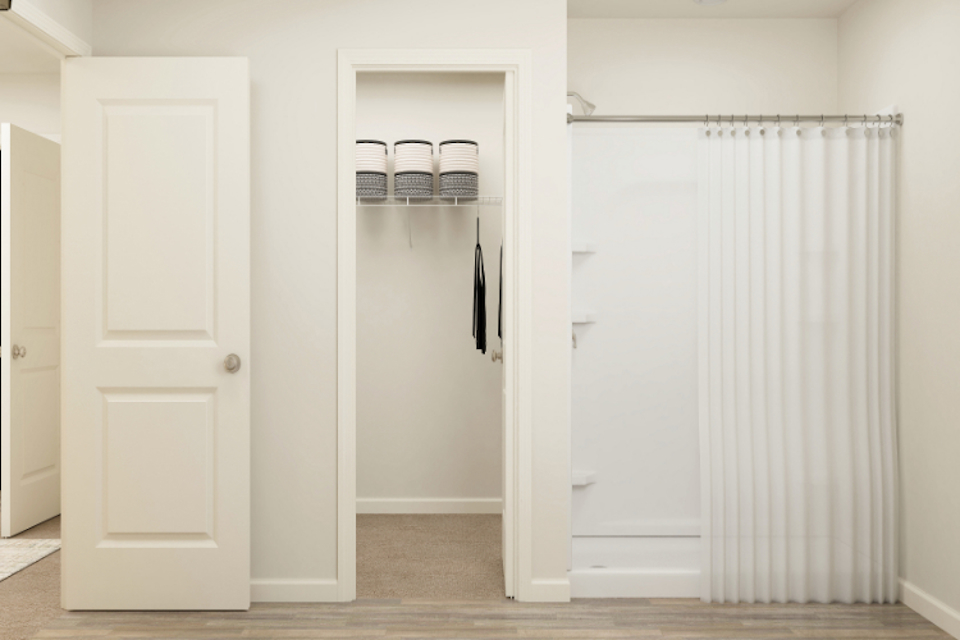 A closet with white doors.