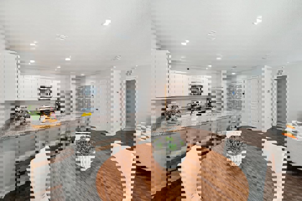 A kitchen with a dining table.