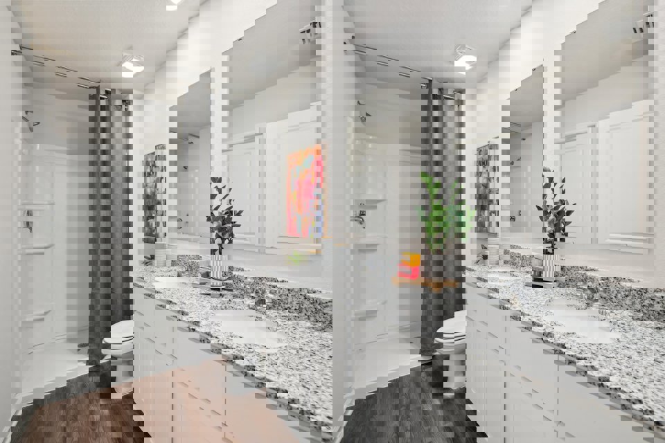 A bathroom with a tub sink and toilet.