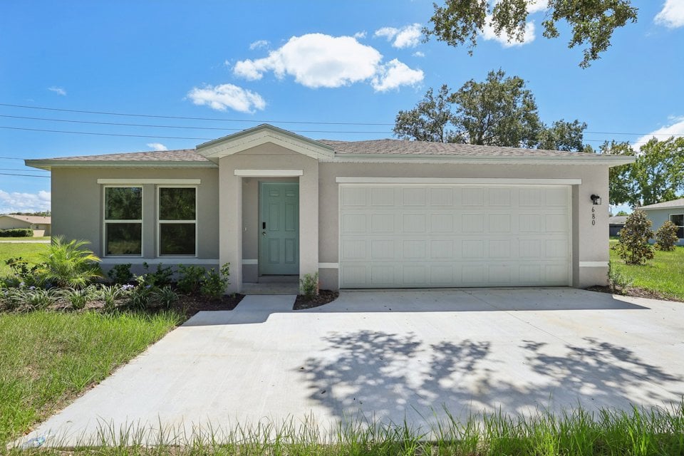 A white house with a garage.