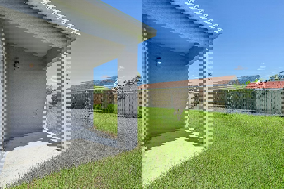 A house with a fence and grass.