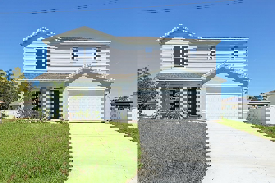 A white house with a driveway.