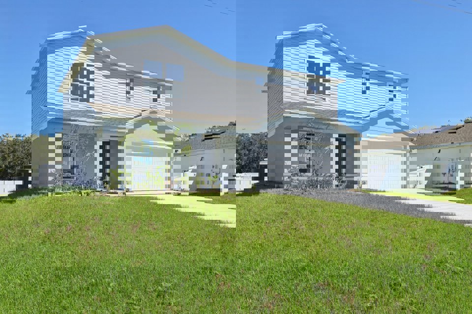 A house with a lawn in front.