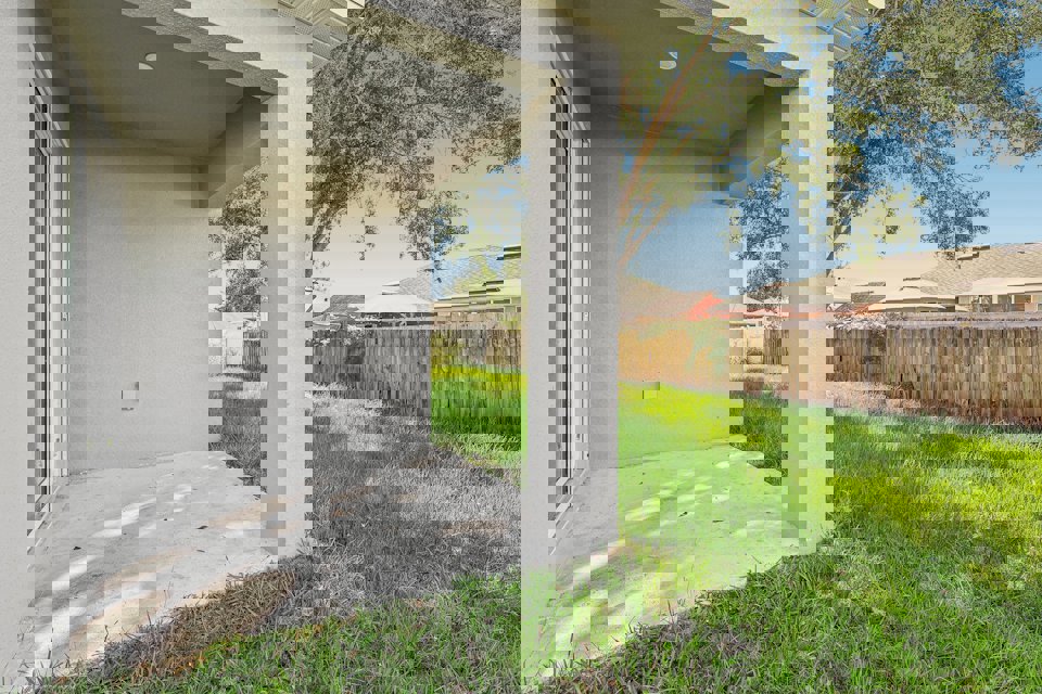 A house with a fence and grass.