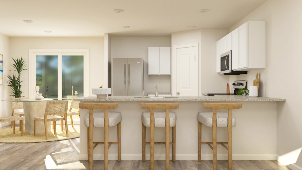 A kitchen with a table and chairs.