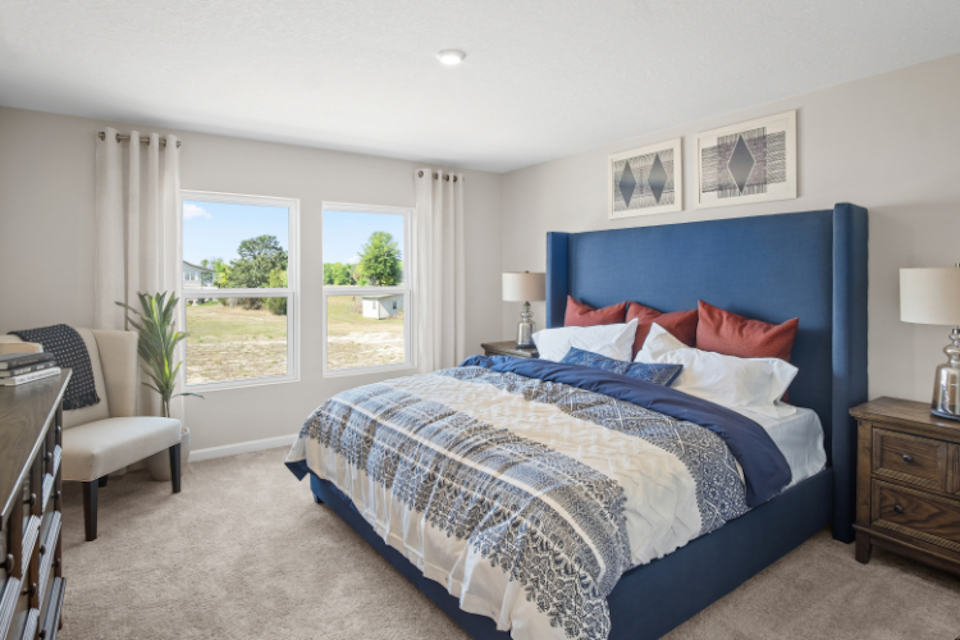 A bedroom with a blue bed.