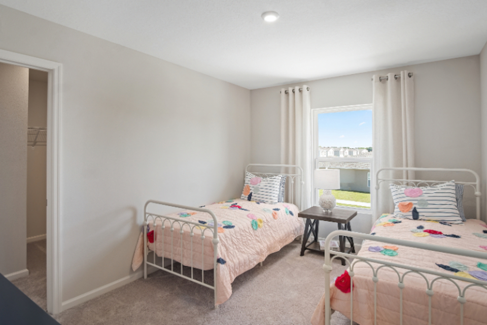 A bedroom with two beds.