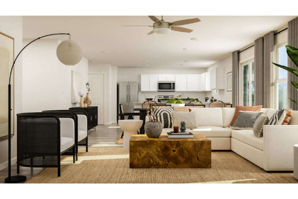 A living room with a white couch and a table.