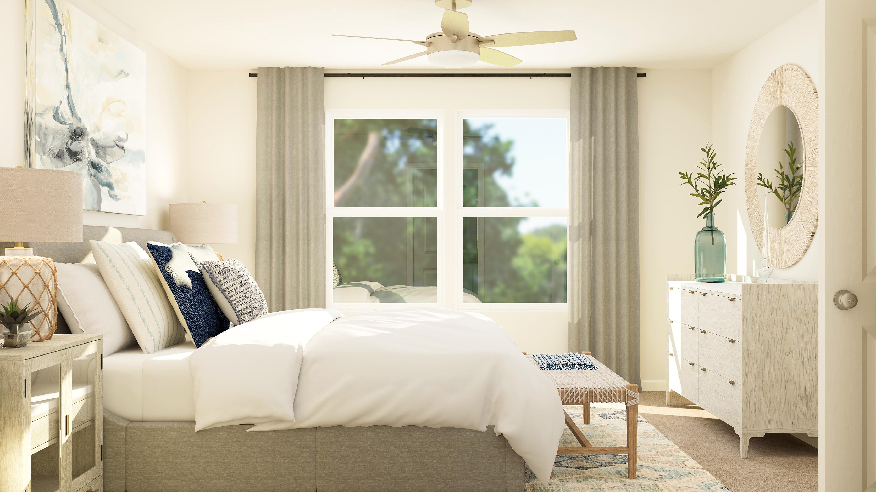 A living room with a white couch and a large window.